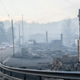 Law enforcement vehicles drive through the smoke near structures destroyed by wildfires in Gatlinburg, Tennessee. (Image: AP)